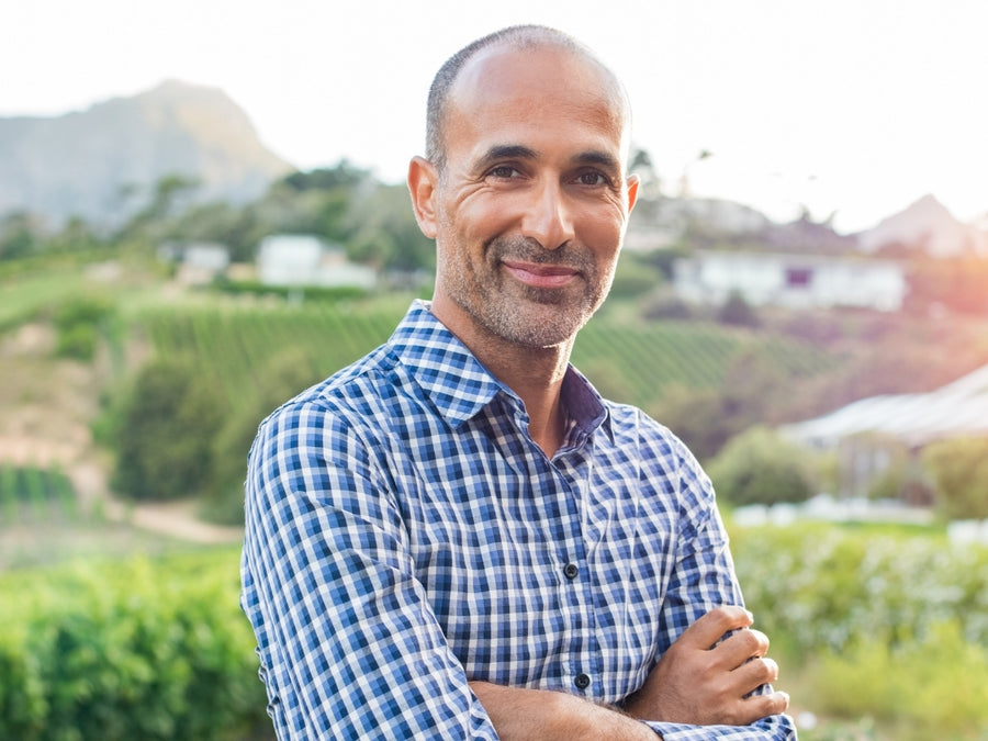 Smiling man outdoors in a checked shirt
